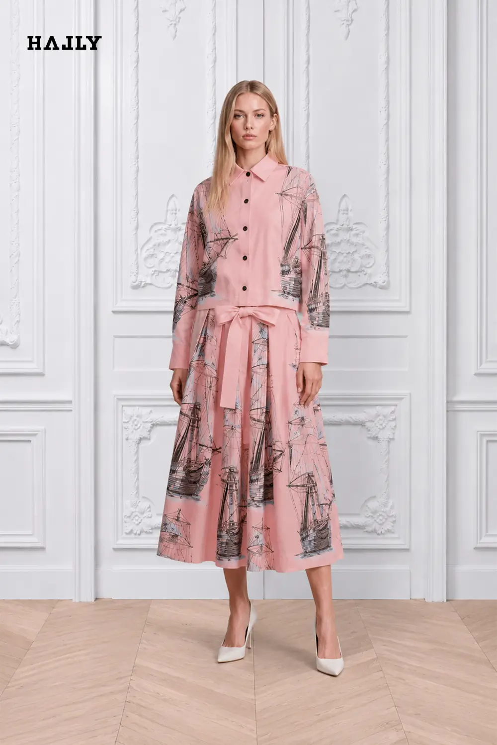 A-blush-pink-shirt-and-skirt-ensemble-adorned-with-intricate-blue-sailboat-illustrations-1